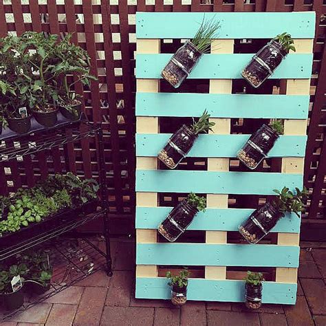 The herb garden is made out of a wooden crate with some crafty work on it. DIY Pallet Mason Jar Herb Garden Tutorial - Hello Creative ...