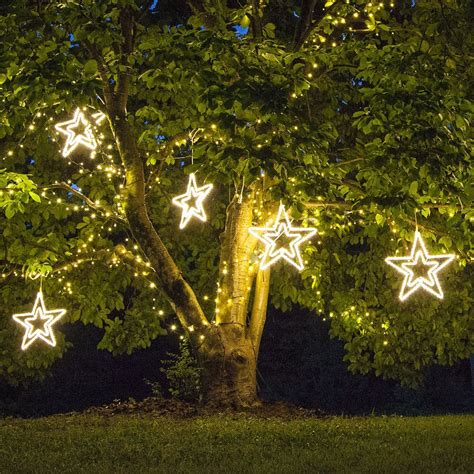 Christmas Stars Hanging From Tree Branches Outdoor Christmas Lights