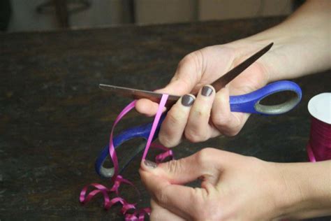 Once you have a few layers, use the threaded needle to sew in the center of all ribbons to hold them then, wrap the thread around center about 4 times and tie off tightly. How to Make a Bow out of Curling Ribbon | DIY Projects