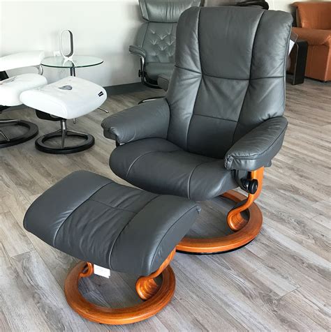 Extremely plush and soft while maintaining a streamlined look, this chair and ottoman are sure to stand out in any space. Stressless Kensington Large Mayfair Paloma Rock Leather ...