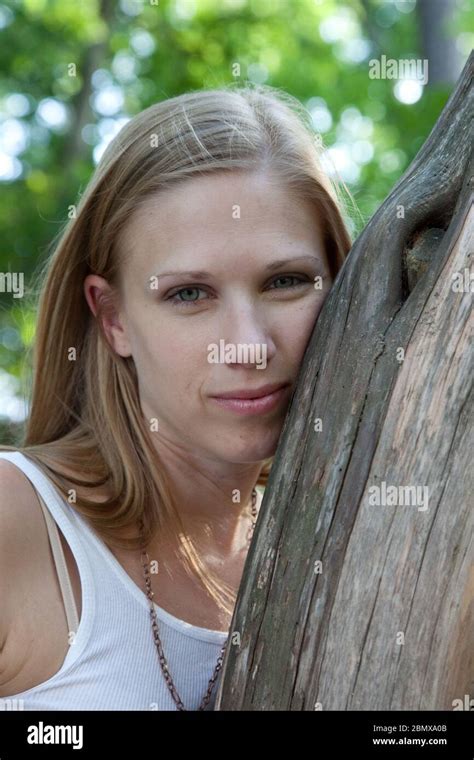 Pretty Blond Woman Outside By A Tree Stock Photo Alamy