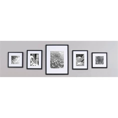Five Black And White Photographs Hanging On The Wall