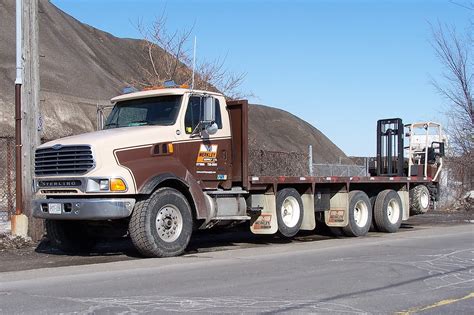 Our mission is to provide good service through our trained and knowledgeable staff by providing a wide variety of. Merkley Supply 4 axle Sterling flatbed building supply del ...