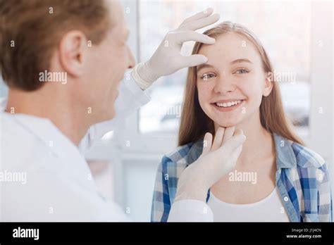 Delighted Dermatologist Examining Patient Skin In The Hospital Stock Photo Alamy