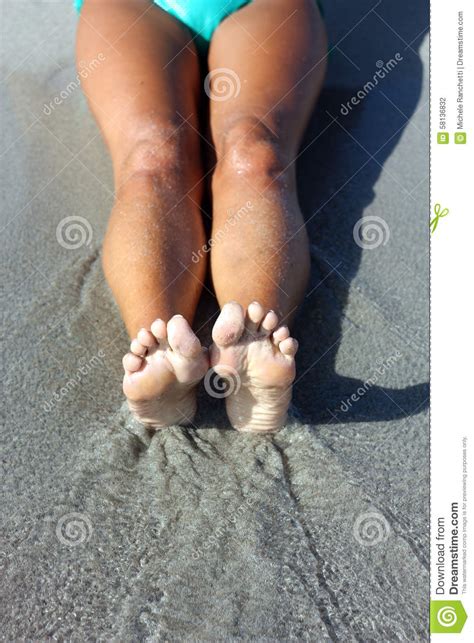 Legs Stretched Out On The Sand Stock Photo Image