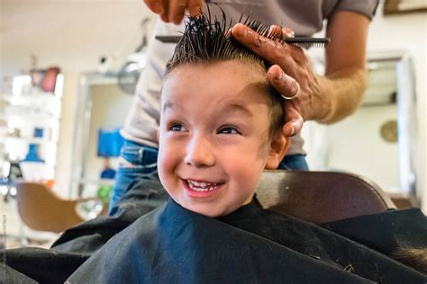 Cute Child Get A Haircut At The Barbershop By Stocksy Contributor