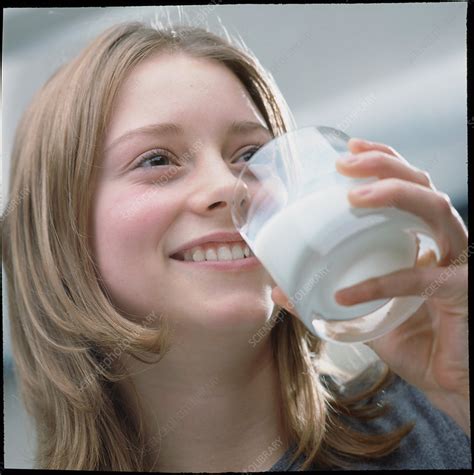 teenage girl drinking a glass of milk stock image p920 0114 science photo library