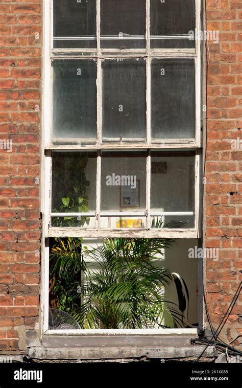 A Partially Opened Window At A Red Brick Property Stock Photo Alamy