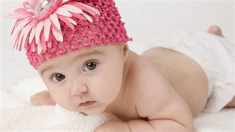 Cute Baby Is Lying Down On White Towel Having Flower Band On Head Hd