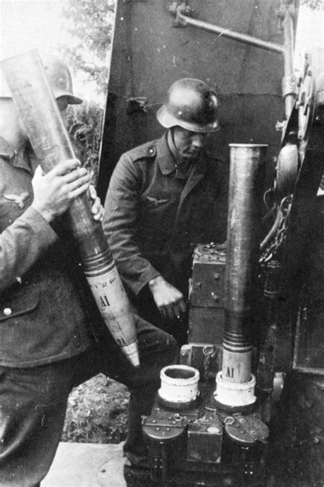 German Flak Gunners Inserting Their 88mm Shells In A Machine Which