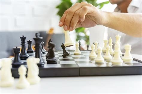 Businessman Playing The Chess Game Business Strategy And Tactic