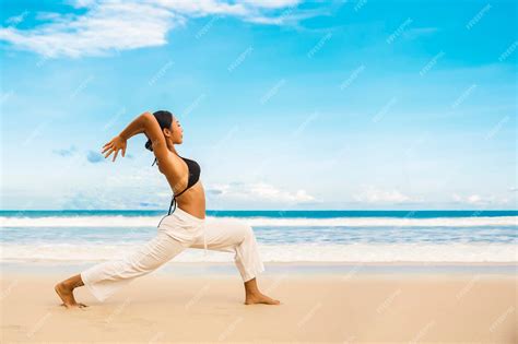 Premium Photo Woman Practicing Yoga At Seashore Of Tropic Beachsports Lady Standing At The