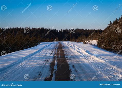 Beautiful Winter Road Through Snowy Fieldssunset And Forests Stock