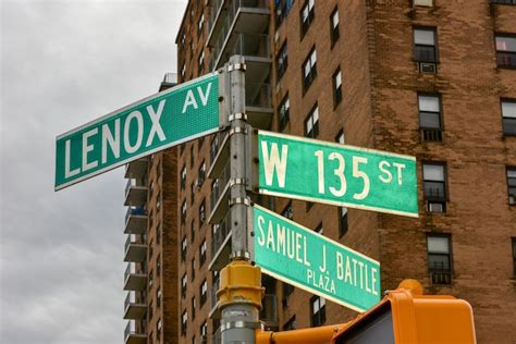 premium photo harlem street intersection at lenox avenue and west 135 st in manhattan new york