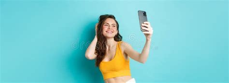 Beautiful Modern Girl Taking Selfies On Vacation Posing In Summer Clothes And Looking At