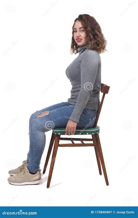 Portrait Of A Woman Sitting On A Chair In White Backgroundlooking At