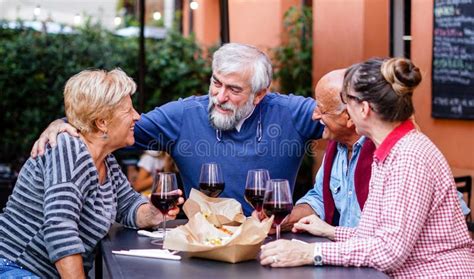 Group Of Old People Eating And Drinking Outdoor Seniors Having Fun