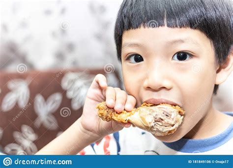 Hungry Asia Little Boy Eating Chicken Leg Child Hand Holding A Fried