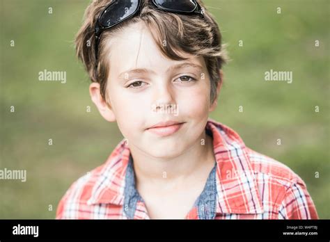 Boy 10 Years Old With Sunglasses And Plaid Shirt Looks Cool In The