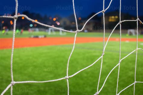 Detailed View Of A Soccer Goal Net And Soccer Field At Night Stock