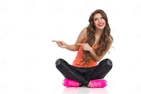 Girl Sitting With Legs Crossed And Pointing Stock Image Image Of