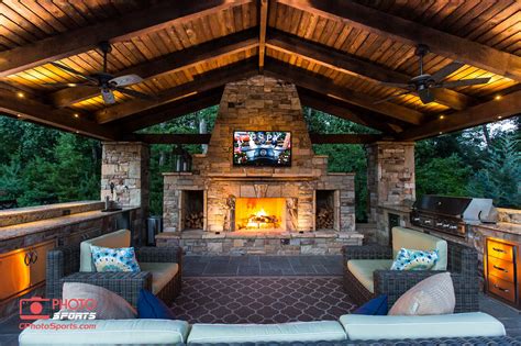 An Outdoor Living Area With Fireplace And Grill