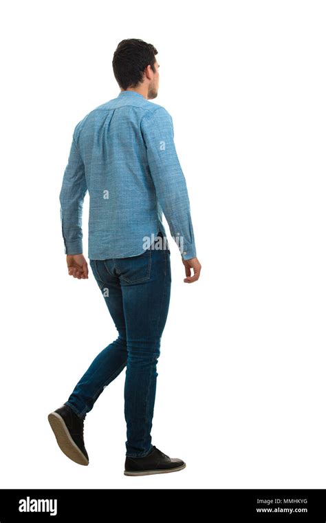 Full Length Back Portrait Of A Young Man Walking Isolated On White