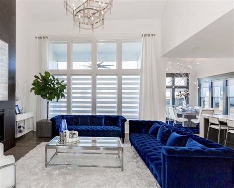 Artwork is often a good starting point for a room's color scheme. Elegant blue and white living room decor with blue velvet ...