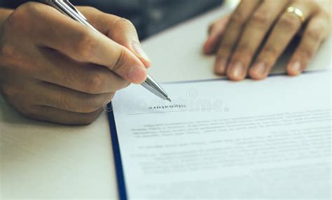 Close Up Hand Man Signing Paper Contract Agreement For Buying House