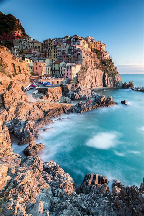Sunset In The Village Of Manarola With Its Pastel Coloured Houses And Its Cosy Dock Cinque