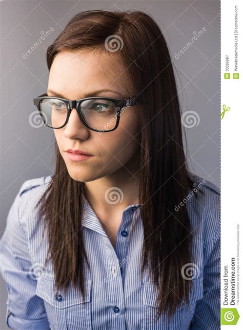 Thoughtful Pretty Brunette Wearing Glasses Posing Royalty Free Stock