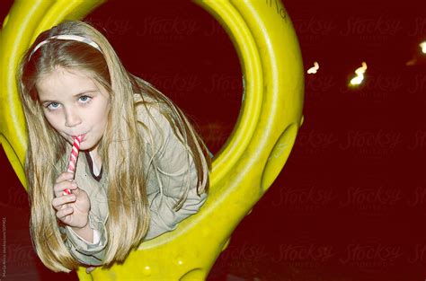 Seven Year Blonde Girl With Lollipop On Playground By Marija Anicic