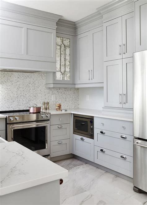 Here, the countertops are made of white marble and there is a grey and white combination in the marble backsplash. Gray Shaker KItchen Cabinets with Engineered White Quartz ...