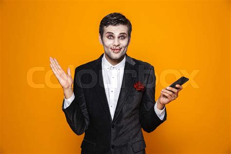 Handsome Cheerful Man Holding Smartphone And Smiling To Camera Stock