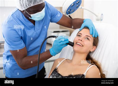 Young Woman Receiving Face Ultrasound Lifting Procedure In Clinic Of