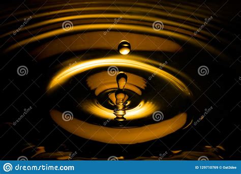 Liquid Gold Drop And Ripple In The Dark Stock Image Image Of Metal