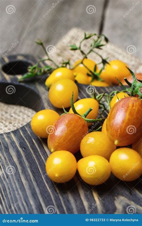 Yellow And Red Cherry Tomatoes On Wooden Cutting Board Stock Image