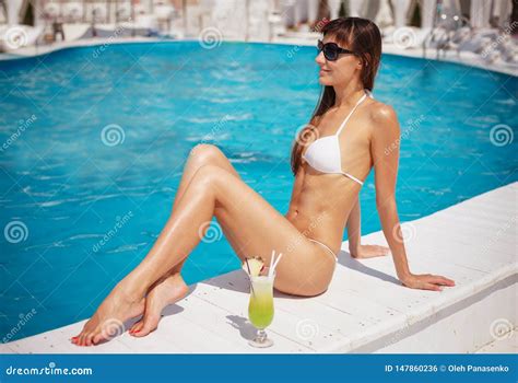 Portrait Of Beautiful Tanned Exotic Woman Relaxing Near Swimming Pool