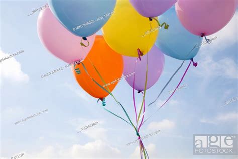 A Bunch Of Balloons Floating In The Air Stock Photo Picture And