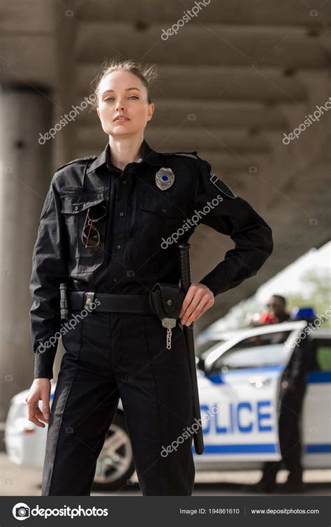 Attractive Female Police Officer Uniform Looking Camera Blurred Partner