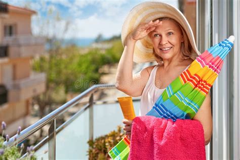 Mature Tourist Woman In Hat On Balcony At Hotel Near The Seavacation At The Resort Concept