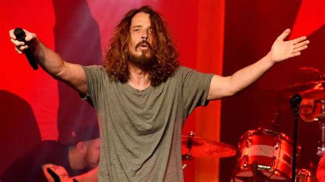 A Man With Long Hair And Beard Holding His Arms Up In The Air While