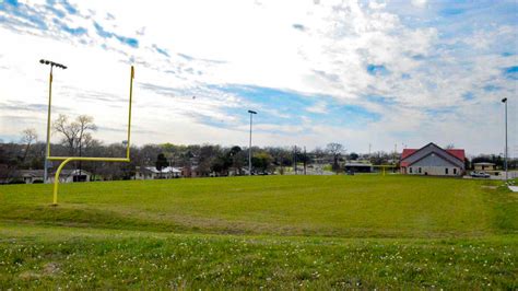 Someone who finds out what a place or location is like by watching travel programs on television, looking at internet websites about travel or reading books about travel. Mean Joe Greene Football Field - Temple, Texas