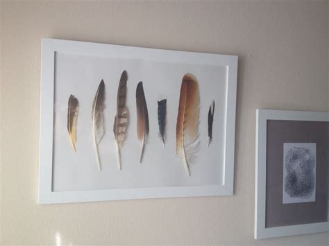 In this eclectic bedroom designed by janie molster, the suzani contrasts with the abstract wall art for an affordable display of wall art, mix in framed pieces with taped up vintage finds or your own artwork. Framed feathers | Feather diy, Wall design, Leaf art
