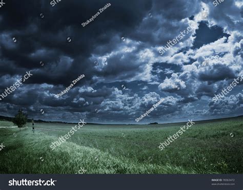 Storm Clouds Over Meadow With Green Grass Stock Photo 78363472