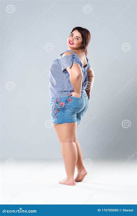 Plus Size Fashion Model In Jean Shorts Fat Woman On Gray Background