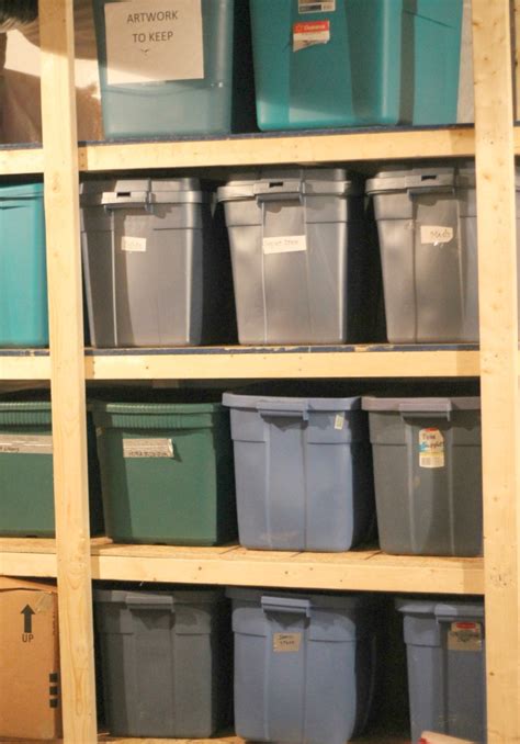 Use plastic bins to stash seasonal items. Our $70 Storage Bin Shelving (Part One) | Garage storage ...