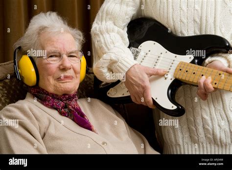 Elderly Lady Wearing Ear Defenders And Looking Smug Stock Photo Alamy