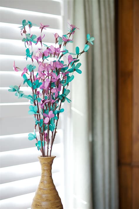 A leafy magnolia branch in a tall clear vase makes a serious statement in this desk area by designer mark d. decorative branches-- beautiful blossom branches | Branch ...