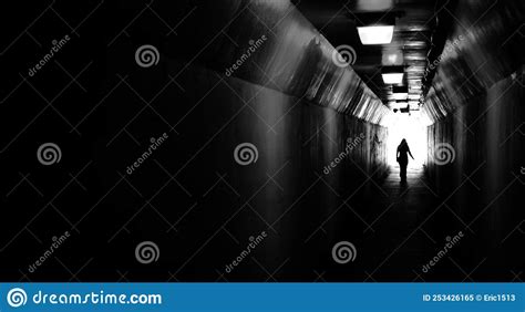 Person Walking Through Tunnel Towards Light At End Accomplishing Goal